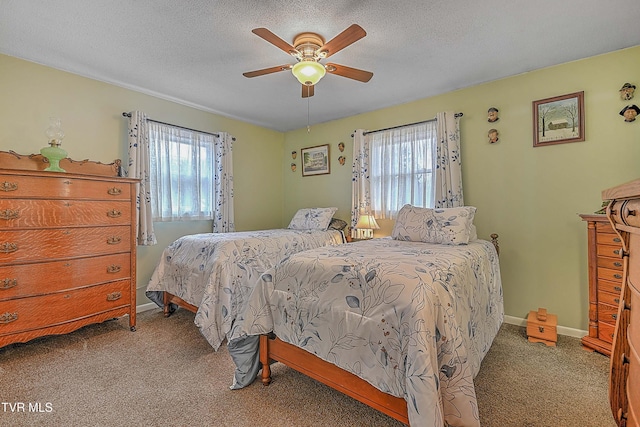 bedroom with a textured ceiling, ceiling fan, and light carpet