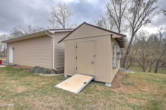 view of outbuilding with a yard