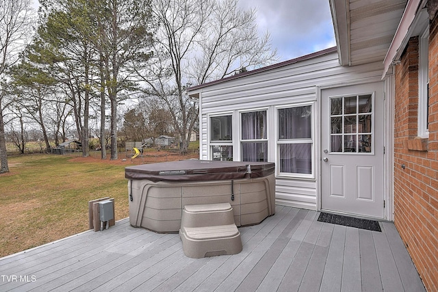 wooden deck featuring a yard and a hot tub