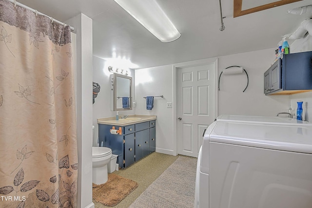 bathroom with washer and dryer, vanity, and toilet