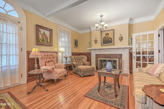 living room featuring crown molding, hardwood / wood-style floors, and a fireplace