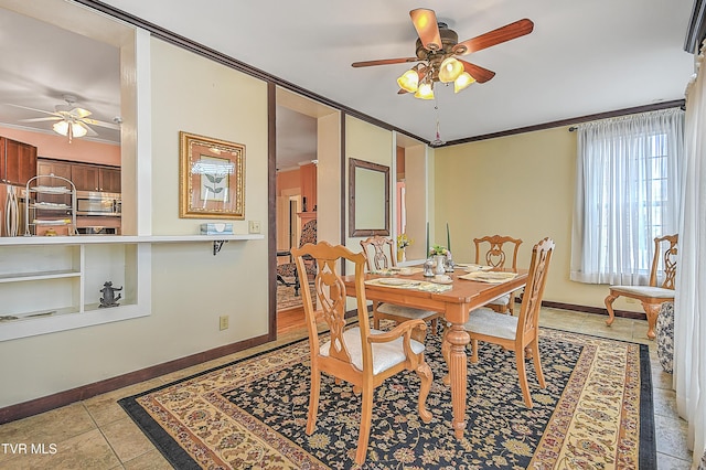 tiled dining space featuring crown molding and ceiling fan