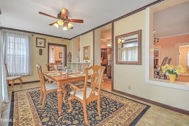 tiled dining space featuring ornamental molding and ceiling fan