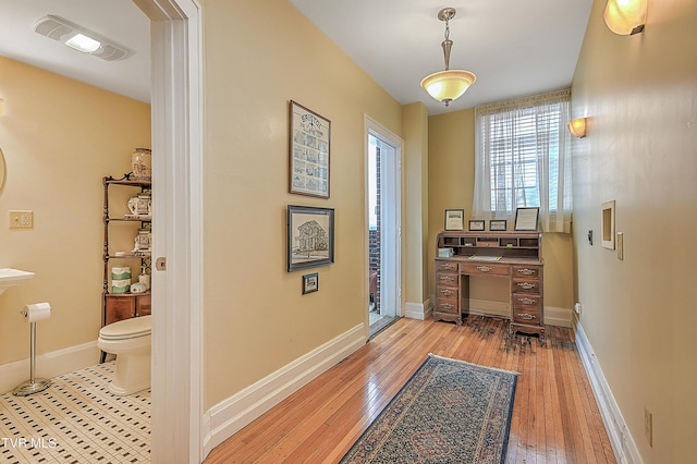 hall with light hardwood / wood-style flooring