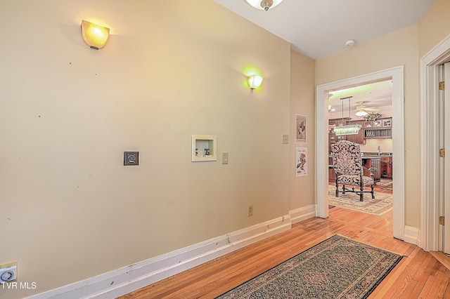 washroom with washer hookup, hookup for an electric dryer, and light hardwood / wood-style floors