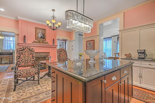 kitchen with crown molding, a center island, and a healthy amount of sunlight