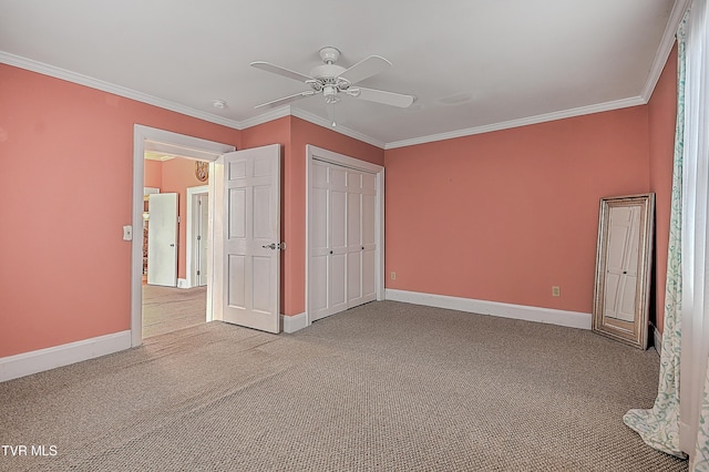 unfurnished bedroom featuring crown molding, ceiling fan, a closet, and light carpet