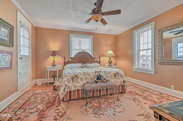 bedroom with multiple windows, crown molding, a textured ceiling, and hardwood / wood-style flooring