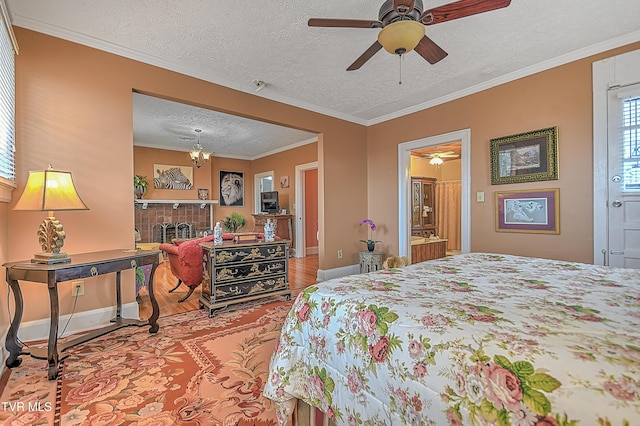 bedroom featuring a tile fireplace, hardwood / wood-style floors, a textured ceiling, and crown molding