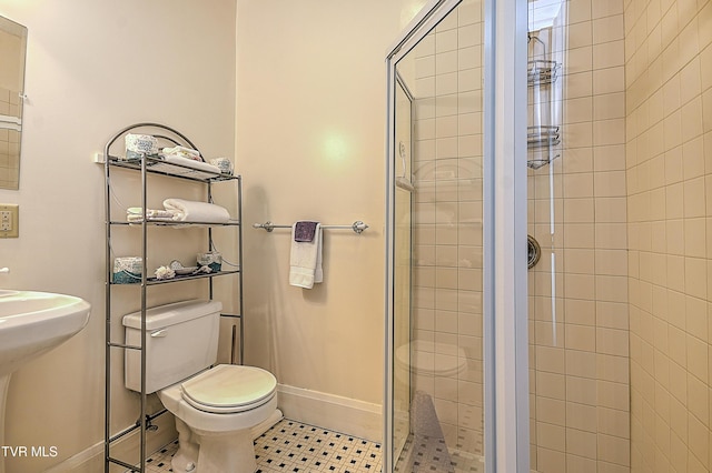 bathroom with walk in shower, toilet, and sink