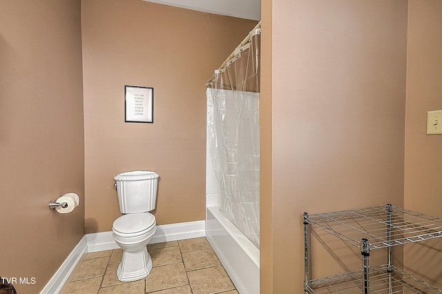 bathroom with shower / tub combo with curtain, tile patterned floors, and toilet