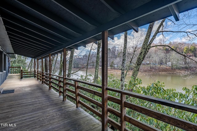 wooden terrace featuring a water view