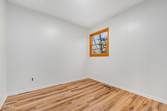 empty room with hardwood / wood-style flooring