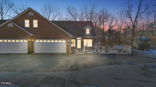 new england style home featuring a garage