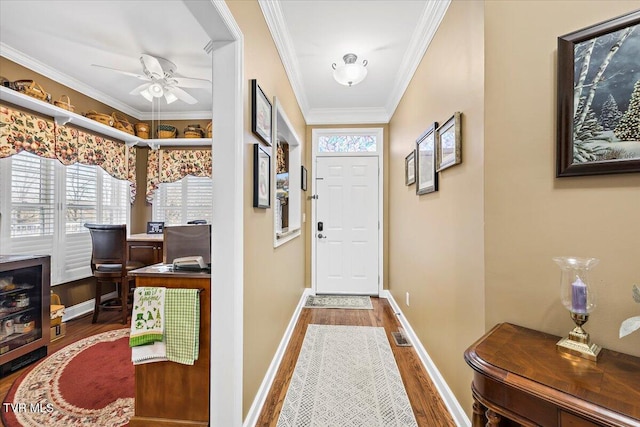 doorway featuring dark hardwood / wood-style floors, ceiling fan, and crown molding