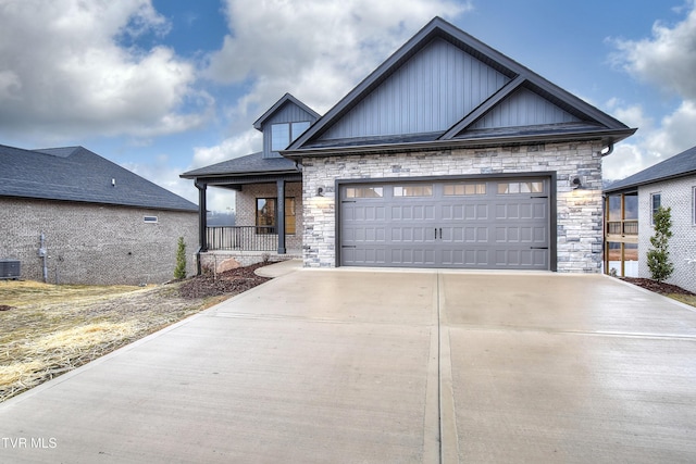 view of front facade featuring a garage, a porch, and cooling unit