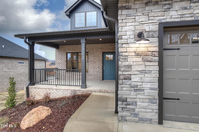 view of exterior entry with covered porch