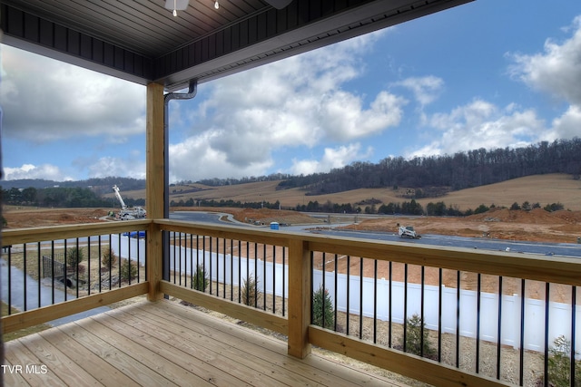 wooden deck with a rural view