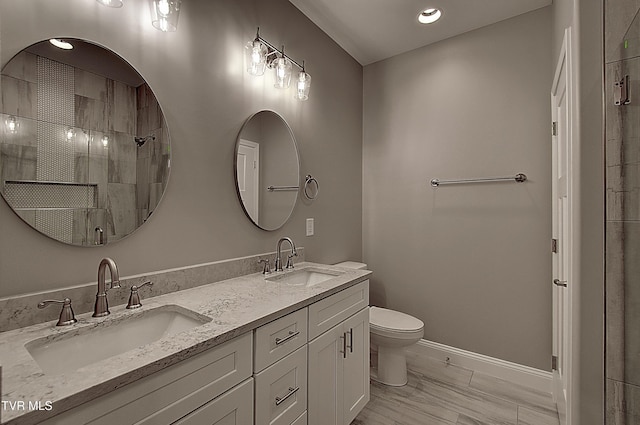 bathroom featuring walk in shower, vanity, and toilet