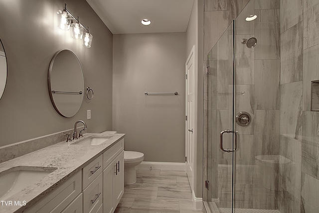 bathroom featuring vanity, toilet, and walk in shower