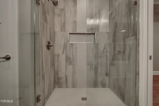 bathroom featuring a shower with shower door