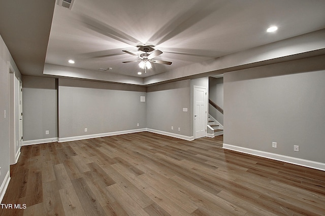 basement with wood-type flooring and ceiling fan