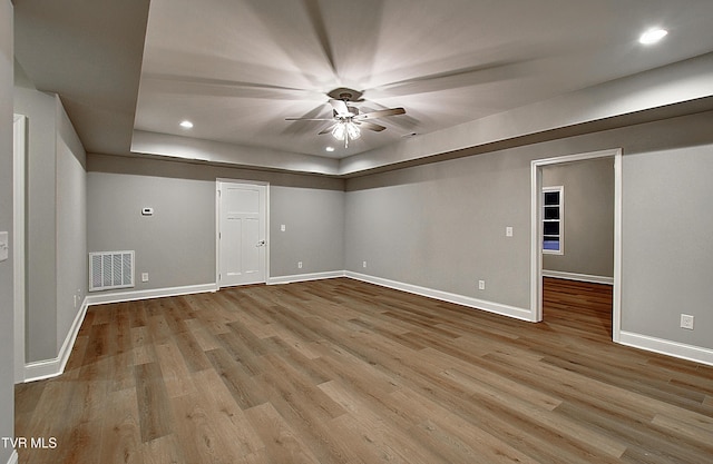 spare room with ceiling fan and light wood-type flooring