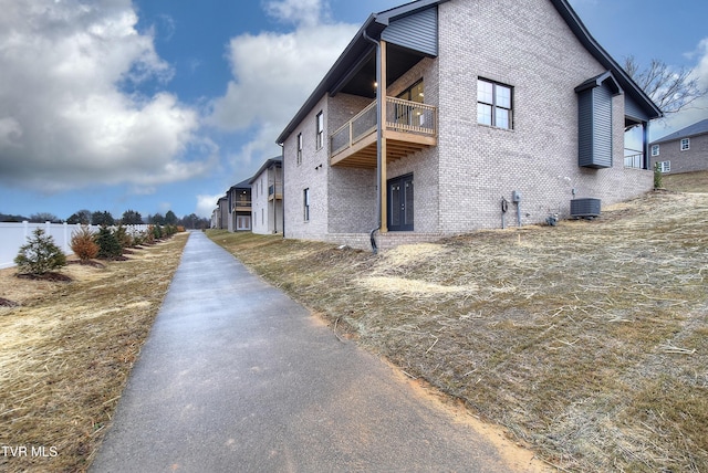 view of side of property with central air condition unit