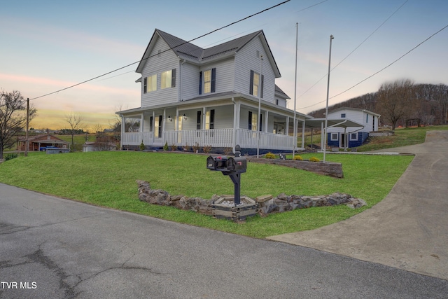 farmhouse inspired home with a lawn and a porch