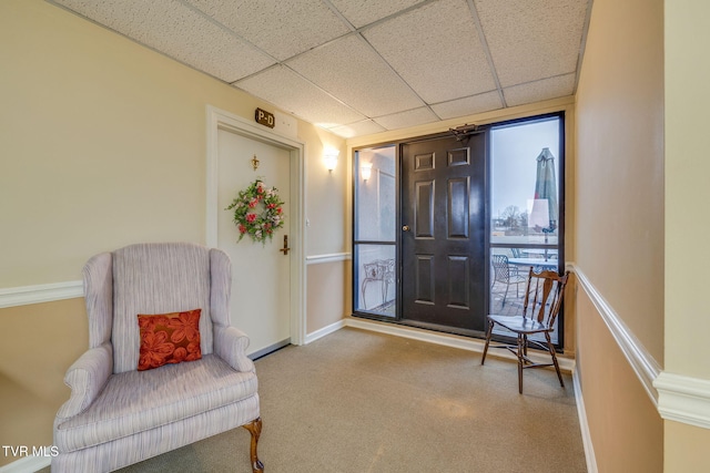 living area with a paneled ceiling