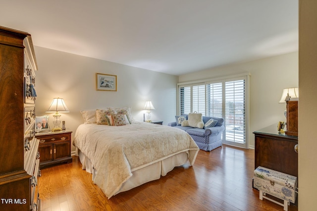 bedroom with access to exterior and light hardwood / wood-style flooring