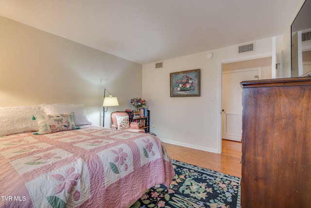 bedroom with hardwood / wood-style floors