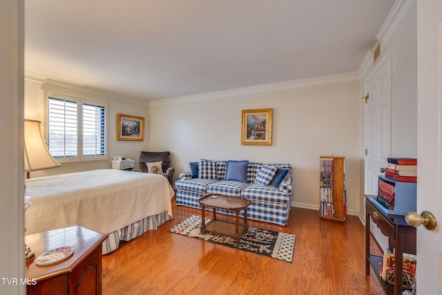 bedroom with hardwood / wood-style floors and ornamental molding