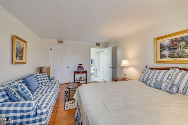 bedroom with hardwood / wood-style flooring and crown molding