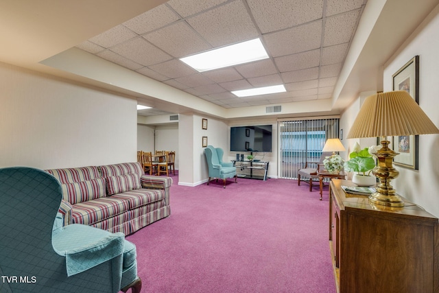 living room with carpet floors and a drop ceiling