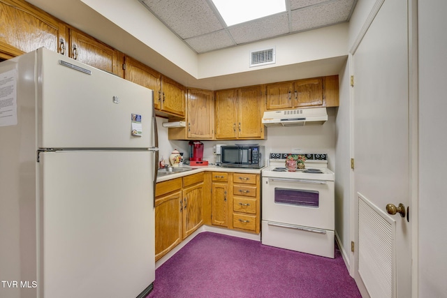 kitchen with a paneled ceiling, sink, white appliances, and dark colored carpet