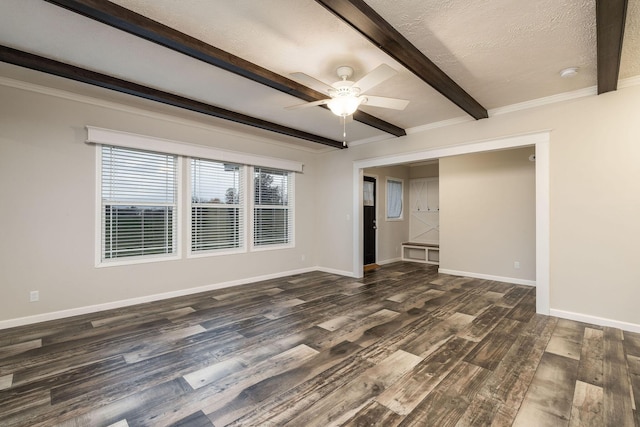 spare room featuring a textured ceiling, ceiling fan, crown molding, dark wood-type flooring, and beam ceiling