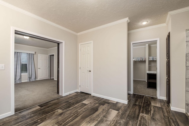 interior space featuring dark hardwood / wood-style floors, ornamental molding, and a textured ceiling