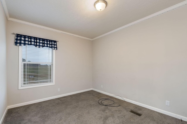 empty room featuring dark colored carpet and crown molding