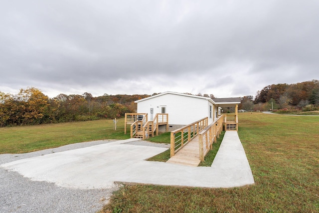 view of property exterior featuring a yard and a wooden deck