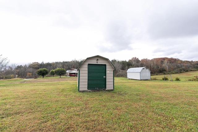 view of outbuilding featuring a lawn and a rural view