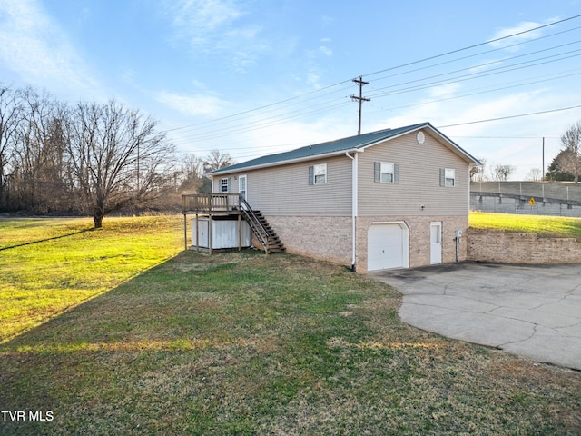 view of property exterior with a yard, a deck, and a garage