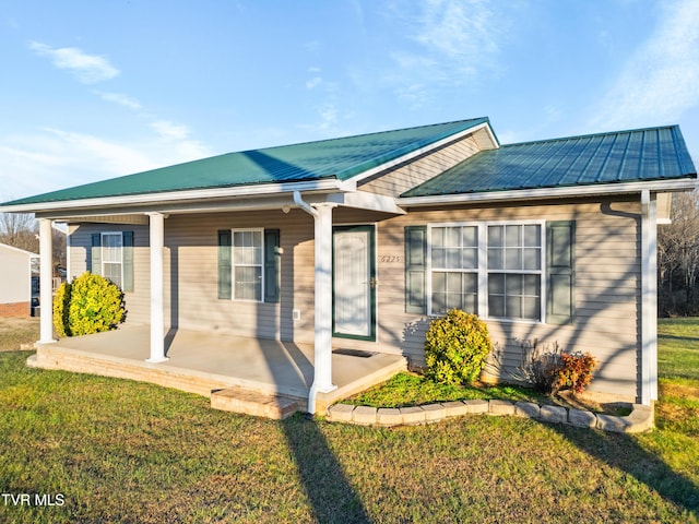 view of front of property with covered porch and a front yard