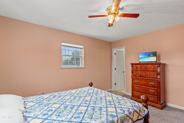 bedroom with ceiling fan and light carpet