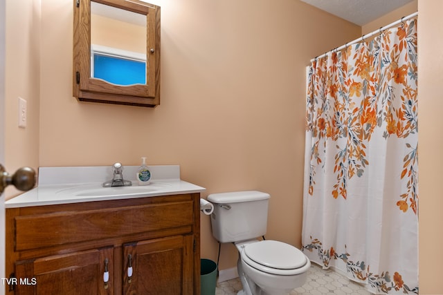 bathroom featuring tile patterned flooring, vanity, and toilet