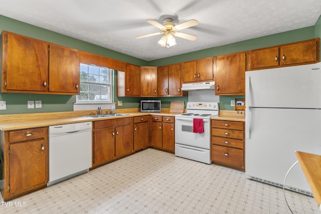 kitchen with a textured ceiling, ceiling fan, sink, and white appliances