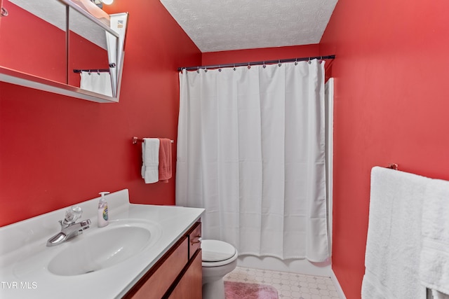 full bathroom featuring vanity, toilet, shower / bath combo with shower curtain, and a textured ceiling