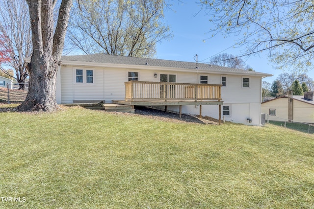 rear view of property featuring a lawn, cooling unit, and a deck