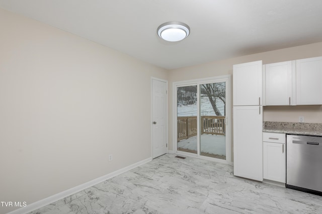 kitchen with light stone countertops, white cabinets, and stainless steel dishwasher