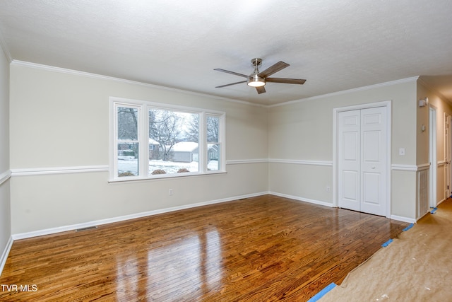 spare room with ceiling fan, crown molding, a textured ceiling, and hardwood / wood-style flooring